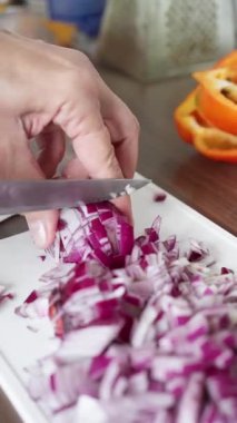 Expertly diced red onions, perfectly prepared for use in cooking dishes or fresh salad preparations. slow motion. High quality 4k footage