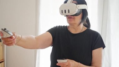 A person fully immersed in the fascinating world of virtual reality, showcasing a highly interactive gaming experience. High quality 4k footage