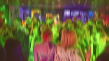 Captivating moments of vibrant nightlife filled with dancing, lights, and energy in a dynamic club setting. Slow motion. High quality 4k footage
