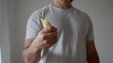 This is a humorous and lighthearted take on a gun gesture that cleverly uses bananas, showcasing creativity and fun. Slow motion. High quality 4k footage