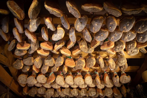 shop interior with hanging hams for seasoning