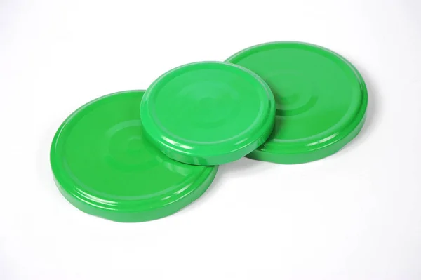 Screw caps for glass jars. For canning, canned food. Green caps on white background — Stock Photo, Image