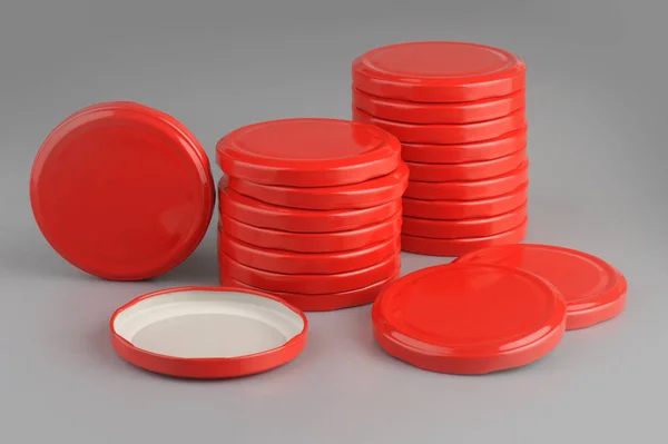 Screw caps for glass jars. For canning, canned food. Red caps on gray background — Stock Photo, Image