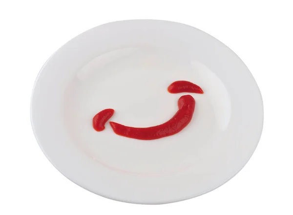 Étalé ketchup sur une assiette sous la forme d'un sourire — Photo