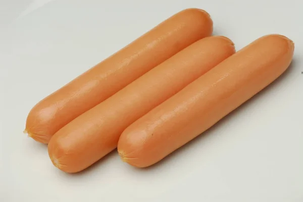 Three frankfurter on an isolated gray background — Stock Photo, Image