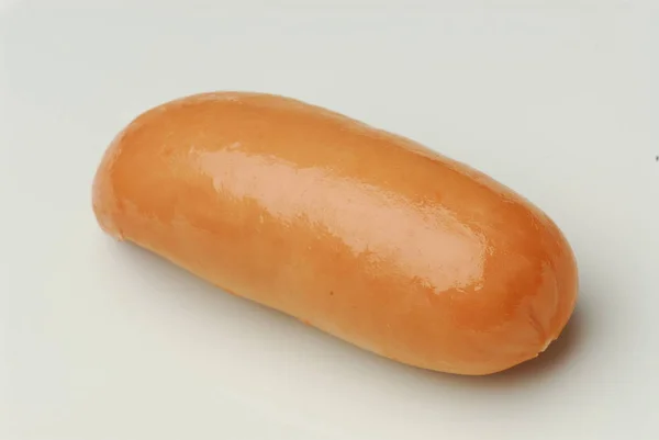 One fresh sausage isolated on gray background — Stock Photo, Image