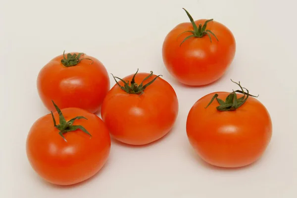 Fresh tomatoes isolated on the gray background — Stock Photo, Image