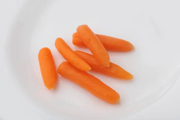 Slices pieces of carrots on a plate — Stock Photo, Image