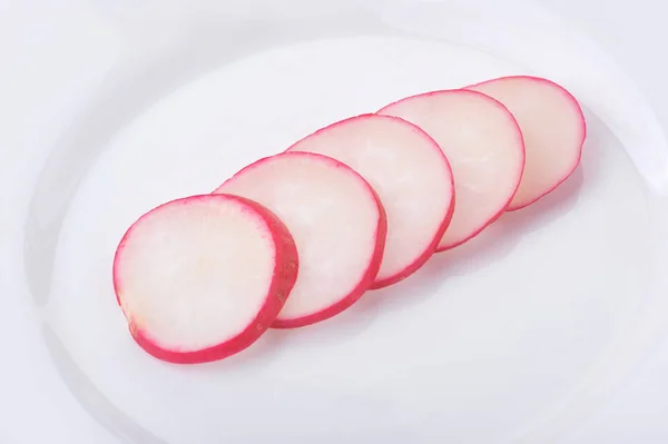 Radish slices isolated on white background on a plate — Stock Photo, Image