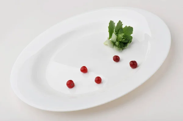 Leaf vegetable on large white plate isolated on white background — Stock Photo, Image