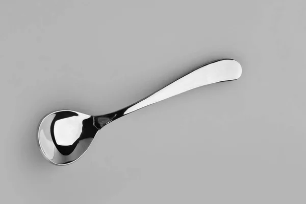 Spoon on a gray background used in restaurants — Stock Photo, Image