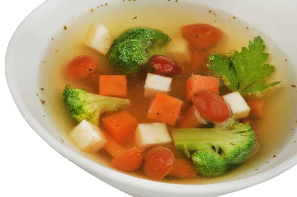 Vegetable soup with cauliflower, potatoes, peas, carrots and parsley on a white isolated background — Stock Photo, Image