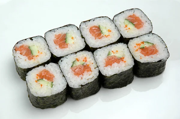 초밥은 흰 접시에 굴러. 맛있는 일본 음식 스시 롤의 클로즈업. — 스톡 사진