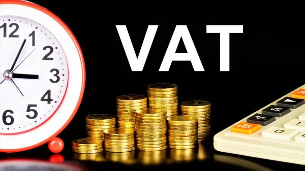 VAT - value added tax. Text inscription on the background of money coins. Fee in cash. Bill payment.