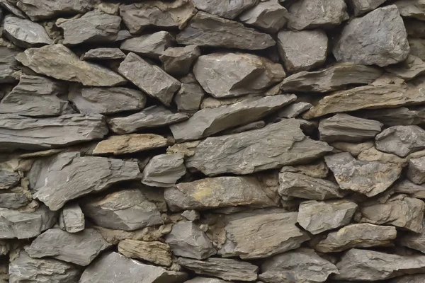 rough taşlar ve çimento sokakta bir gri taş duvar çit dokusuna