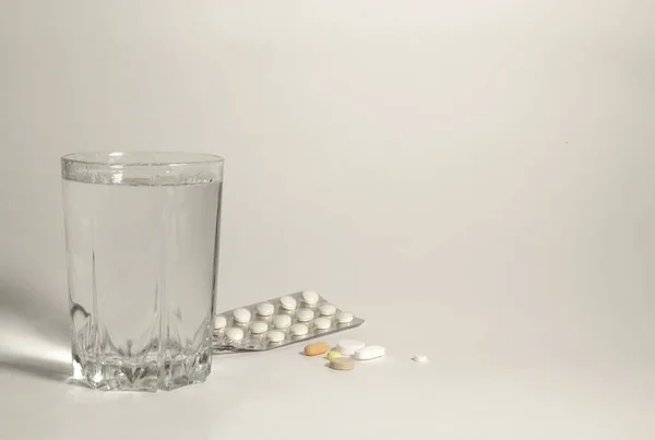 a glass of water and pills the path to recovery on a white background