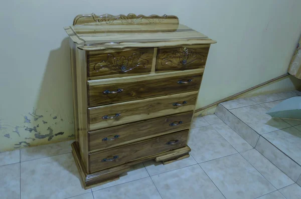 Six drawers Chester Drawer made from natural wood cut dried treated and polished to highlight the natural grain pattern. On front of draw and dash board are artistic carving designed. Each drawer has a pull handle, one with keys.