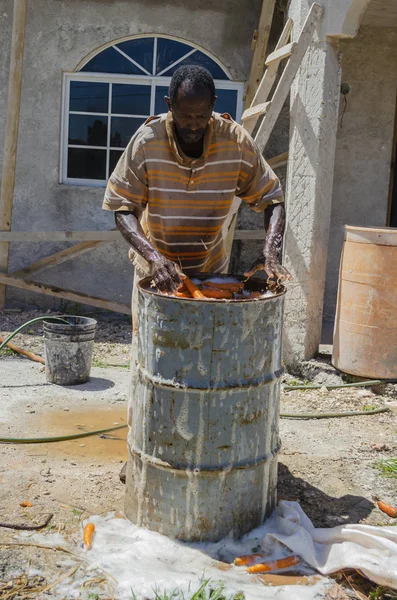 Man Unfinished House Stands Metal Drum Filled Carrots Submerged Soap — Stock Photo, Image