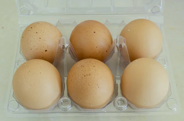 A half dozen eggs is stocked in a plastic egg box that is sectioned, separation each egg for protection.