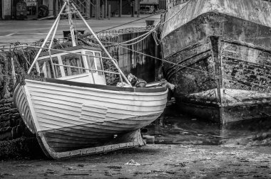 Su düşük tide bir Harbor, küçük bir balıkçı tekne bir siyah beyaz resim