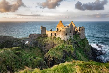 This is a picture of the ruins of Dunluce Castle in Northern Ireland.  It was built in the 13th century on the top of a sea cliff looking out to the Atlantic Ocean clipart