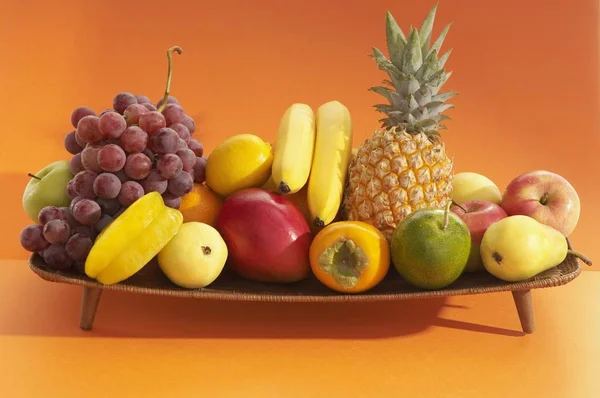 Fresh Fruits Wooden Stand Orange Background — Stock Photo, Image