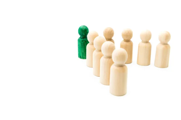 Green figure leading group of wooden figures in spearhead formation, isolated on white background. Leadership concept