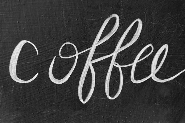 Coffee word handwritten with chalk on blackboard, coffee shop sign — Stock Photo, Image