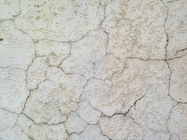 old concrete wall covered in scratches and cracks, background drain texture