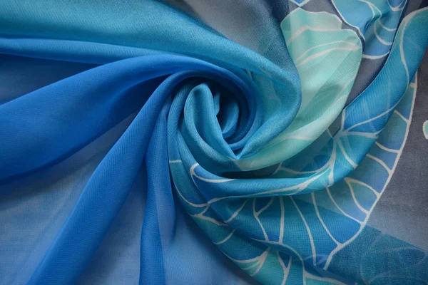 Blue silk scarf with floral patterns, folded drapery circular waves