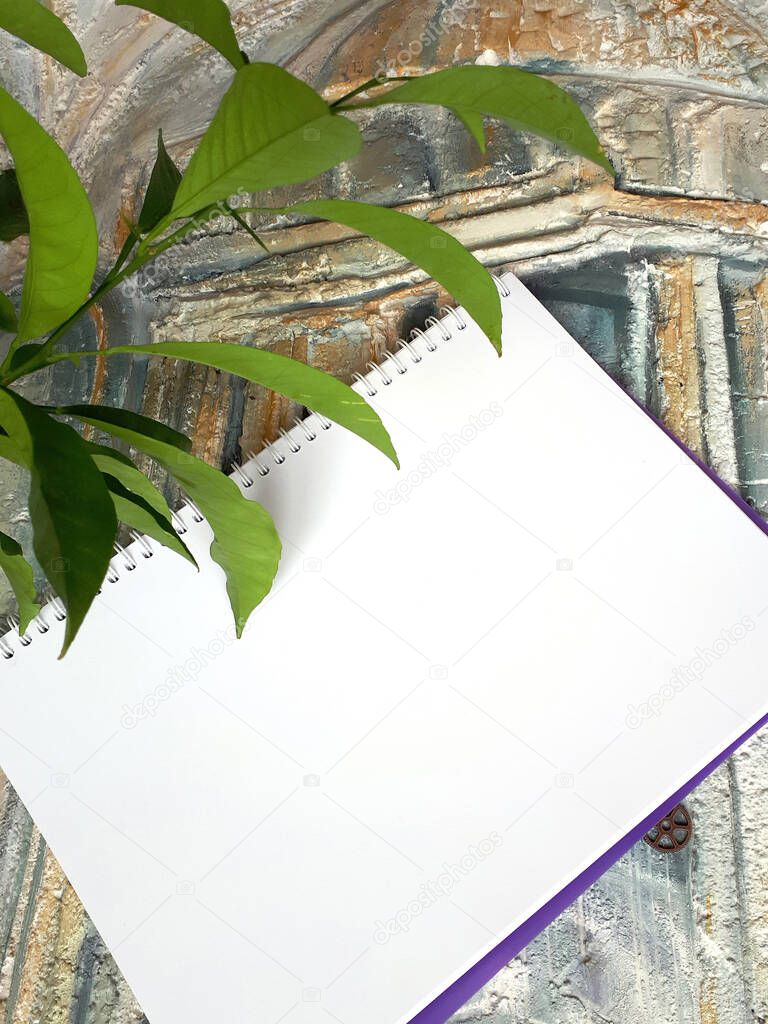 notepad on an acient wall with a plant
