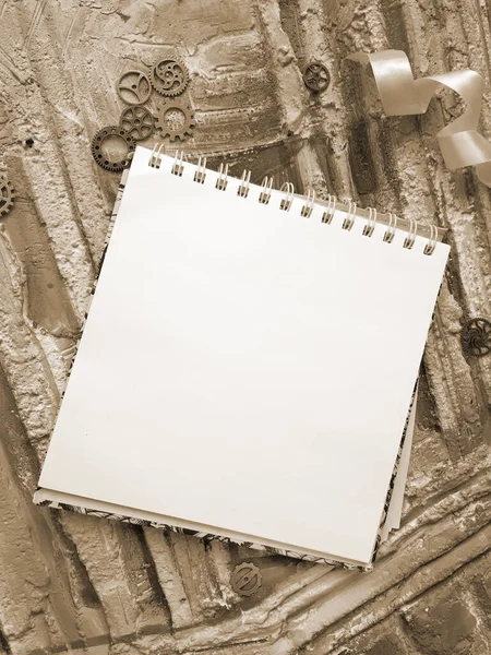 notepad for the sketch against the background of in retro style, sepia