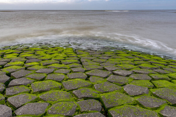 Stone dock diving in to sea on the beautiful Dutch beach 