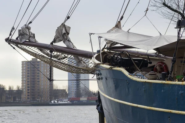 Traditional Dutch ship in the Rotterdam port with the modern buildings in the background