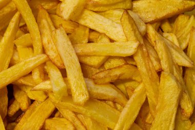 Arka plan lezzetli patates yakın çekim altın rengi olarak lezzetli Fransız kızartması