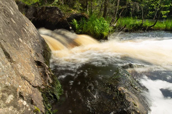 beautiful waterfall landscape on granite stones. fast water flow with blur effect