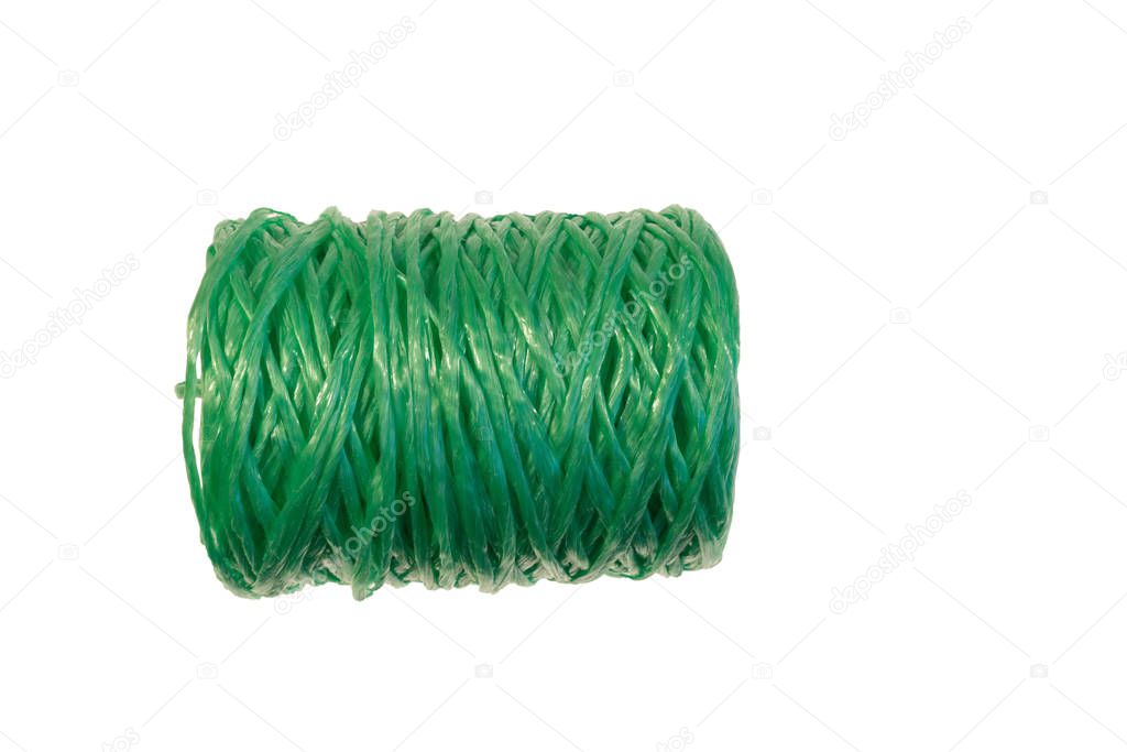 coil of green nylon threads on white isolated background. sewing accessories