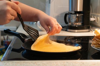 Krep bir tavada kızartın. bir elektrikli soba üzerinde krep pişirme süreci