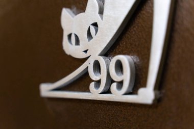 doksan dokuz numara ve metal ön kapıda bir kedi.