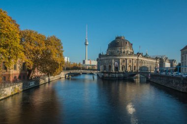 Berlin cityscape with museum island and the river Spree in autumn. In the background the TV tower is visible in the blue sky on sunny day