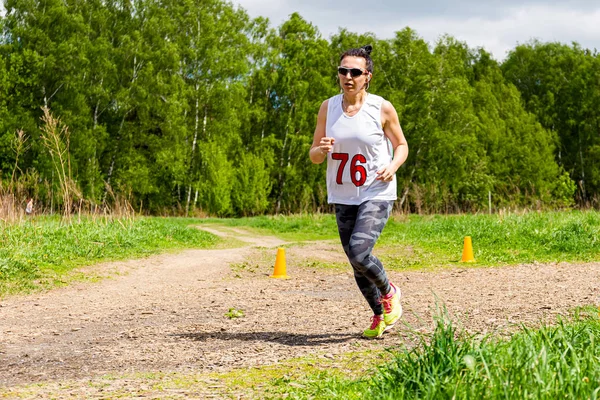 Een volwassen vrouw is bezig met rennen in de natuur — Stockfoto