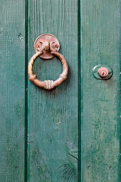 Vintage green door with knocker