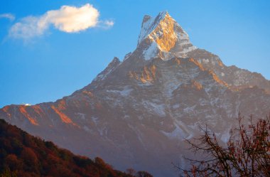mountain peak of Machapuchare. A mountain in the Annapurna Himalayas of north central Nepal clipart