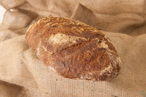 rye black bread on burlap background