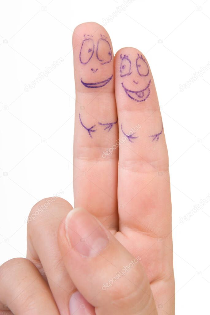 fingers on a female hand with painted faces on a white background
