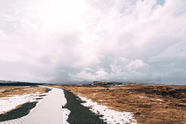Готель на пагорбі, проти хмарного неба, з сніговою бурею в Ісландії.. — стокове фото