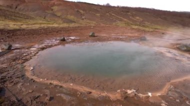 İzlanda 'nın güneybatısındaki Gayzer Vadisi. Meşhur turist eğlencesi Gaysir. Jeotermal bölge Haukadalur. Laugarfjall tepesinin yamaçlarında Strokkur gayzerleri.
