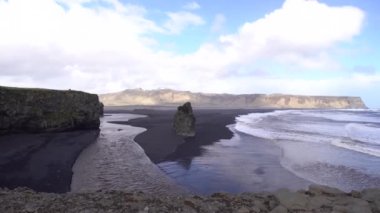 Kara kumsalda fırtınalı, kasvetli bir gün. İzlanda, Avrupa 'nın güneyinde Vik Reynisfjara, Atlantik Okyanusu' nda büyük dalgalar.