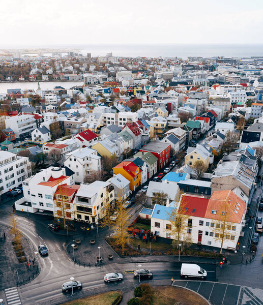 Reykjavik aerial view, downtown colored houses contrast with colors in the sky, the sea and mountain in the background. High quality photo