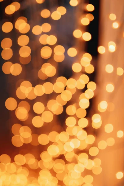 Abstract bokeh lights with soft light background. Garland lights on a black background.